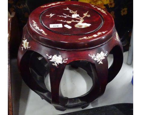 An Oriental stool/stand with inlaid mother of pearl decoration.