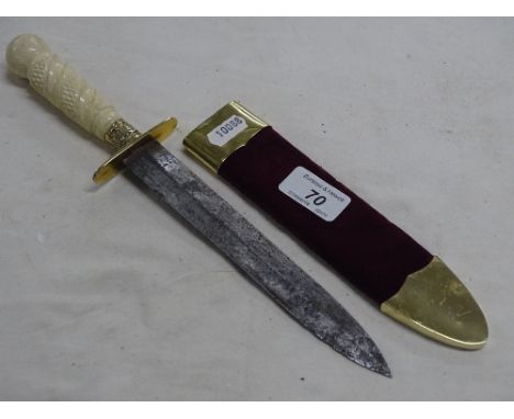 A ceremonial dagger with ivory hilt and gilt mounted scabbard.