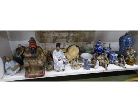 A shelf of Oriental figures, Chinese vase, etc.