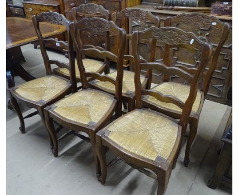 A set of French oak ladder back and rush seated dining chairs.