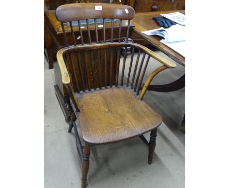 A 19th century bow arm stick back Windsor elbow chair.