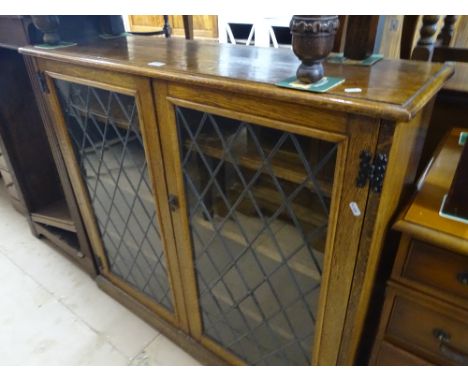 An oak bookcase with 2 lead light glazed doors, width 3'8", height 3'6", depth 12".