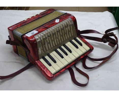 A Hohner small piano accordion.