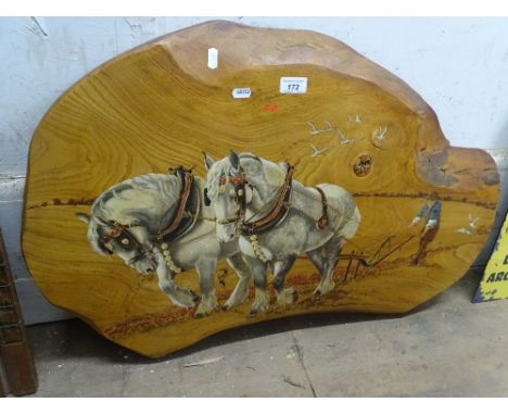 An elm panel with painted design of Shire horses pulling a plough.