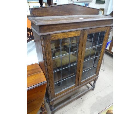 1920s oak lead light glazed 2-door bookcase on barleytwist legs, width 3'.