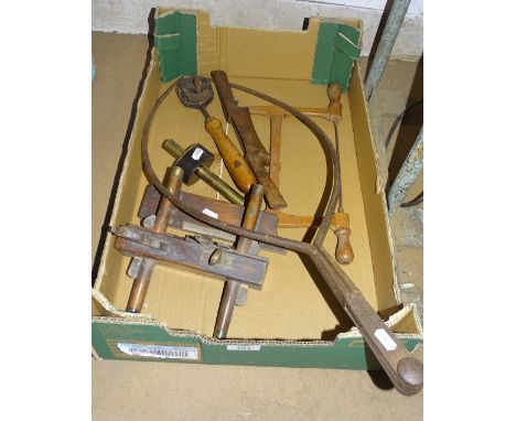 A pair of early tree calipers, miniature wooden bow saw, brass mounted plough plane, unusual swivel head plane, gauge, etc.