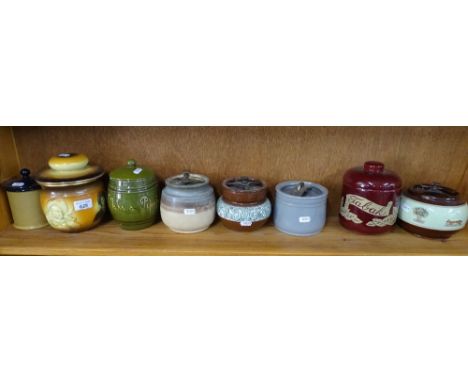 A shelf of tobacco jars including Bourne Denby and Wardle, (8).