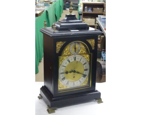 A mantel clock in ebonised case.