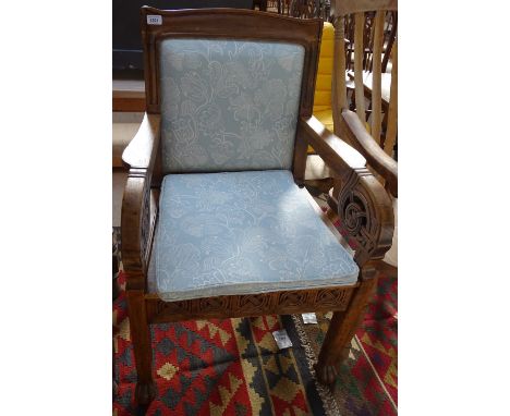 An early 20th century Celtic Norwegian Arts and Crafts armchair, in profusely carved pine with recent upholstery