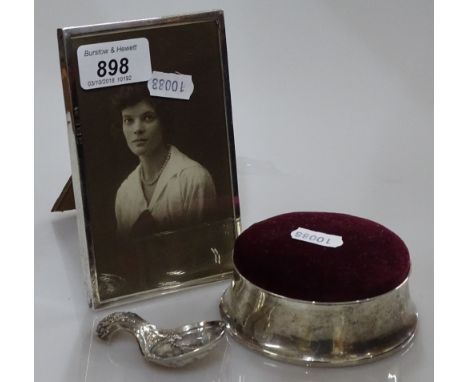 A silver photo frame Birmingham 1915, a silver pin cushion and a plated caddy spoon