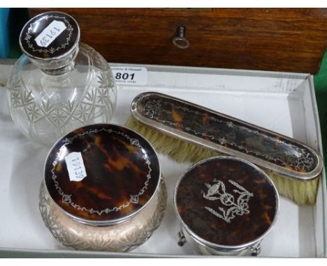 A 4-piece tortoiseshell and silver-mounted dressing table set to include brush, powder bowl, trinket box and scent bottle