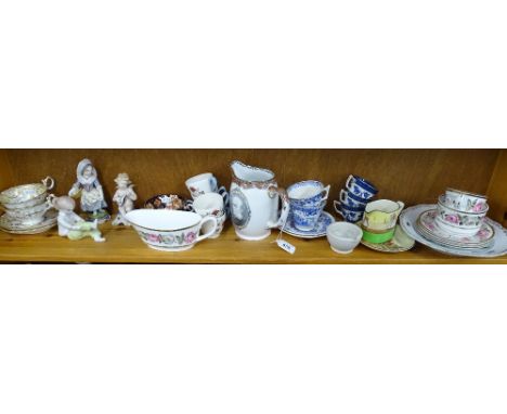 A shelf of figures, cabinet cups and saucers, a Victorian jug etc