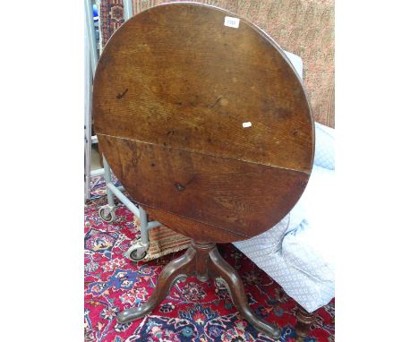 A George III oak tilt-top tripod table, W 76cm