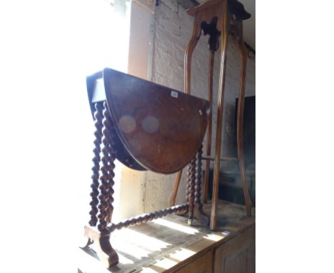 A figured walnut Sutherland table on bobbin turned legs and a walnut jardiniere stand