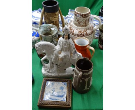 An 18th century framed Delft tile, a Staffordshire figure, vases and a jug
