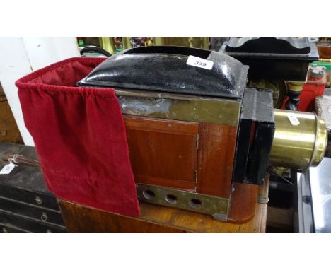 An Edwardian mahogany and brass magic lantern, with original case