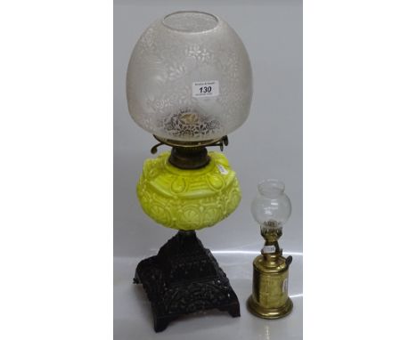 A Victorian yellow glass and cast-iron oil lamp with etched glass shade, height 19.5", and a small French brass oil lamp (2)