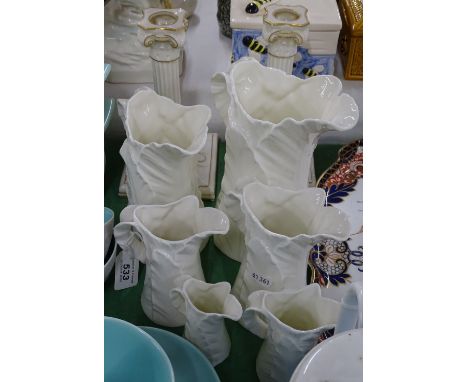 A pair of Victorian Royal Worcester candlesticks, and a graduated set of 6 Worcester jugs