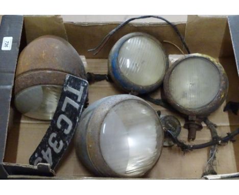 4 Vintage vehicle headlamps and a motorcycle number plate