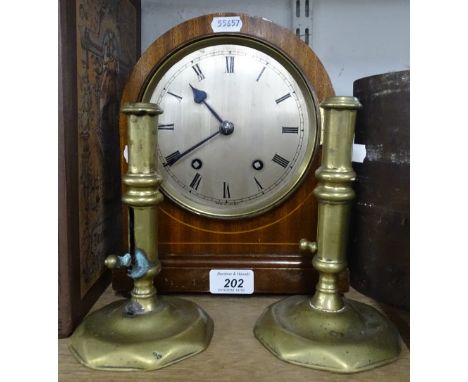 A mahogany cased mantel clock and pair of brass candlesticks