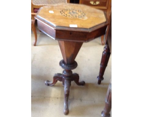 A Victorian trumpet work box on a carved tripod legs.