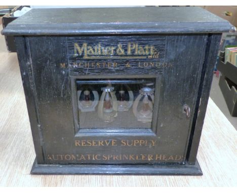 Mather & Platt - stained oak wall cabinet with gilt lettering containing 12 automatic sprinkler heads and spanner, 11.5"