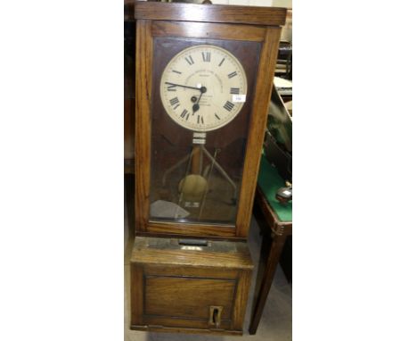 A Gledhill Brook ''Time Recorder Ltd'' clocking in clock in oak case