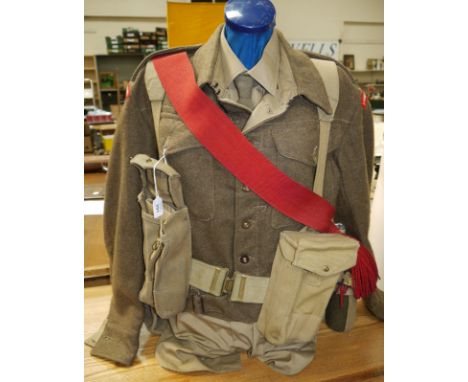 A LANCASHIRE FUSILIERS WW11 battle blouse complete with webbing, canvas bags and trenching tool (set up on mannequin)