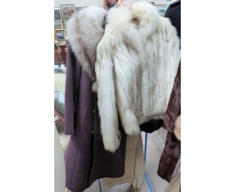 A white fur short jacket and purple coat with fur collar