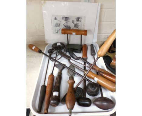 A collection of steel hatters side irons and other related tools 