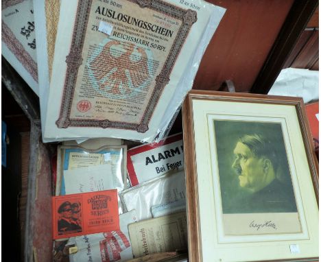 A framed portrait of Adolf Hitler and a selection of ephemera