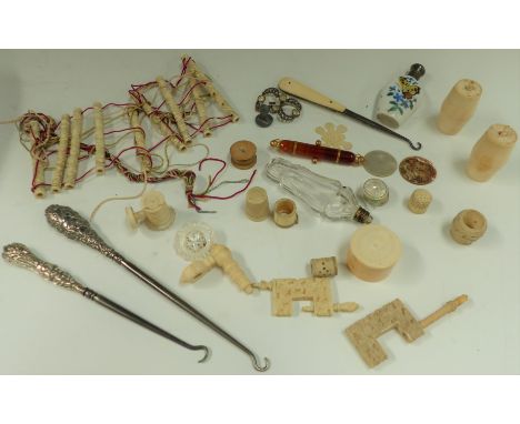 A selection of sewing requisites including clamps, cotton barrels, scent bottles, silver handle button hooks etc