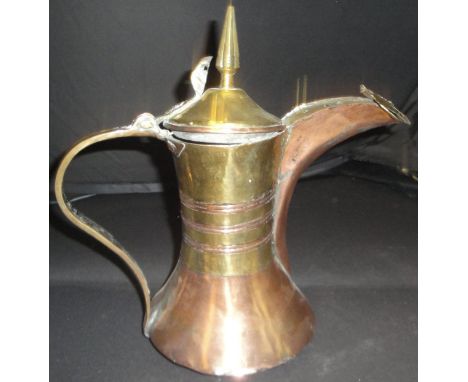 A 19th Century Turkish copper and brass coffee pot with tapering brass finial and cylindrical brass neck with copper ribs and