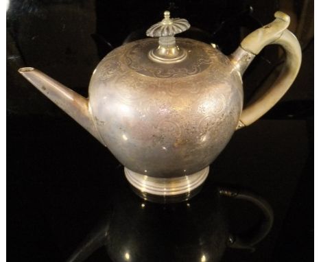 A George II silver teapot of inverted pear form with engraved scrolling and foliate decoration to the shoulders, ebonised fin