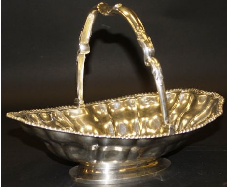 A George IV silver fruit basket with applied rim and swing handle set with armorial to top (by Paul Storr, London, 1823), app