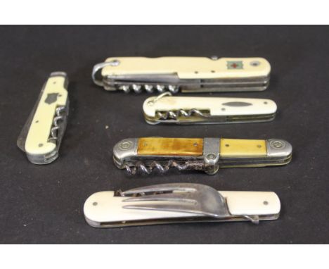 A collection of ivorine and ivory cased pocket knives including a Swiss flag decorated knife, an ivory cased knife with fork 