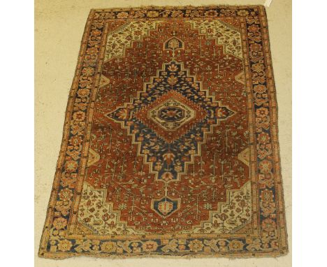 A Persian carpet, the central panel set with floral decorated medallion on a profusely floral decorated rust ground, within a