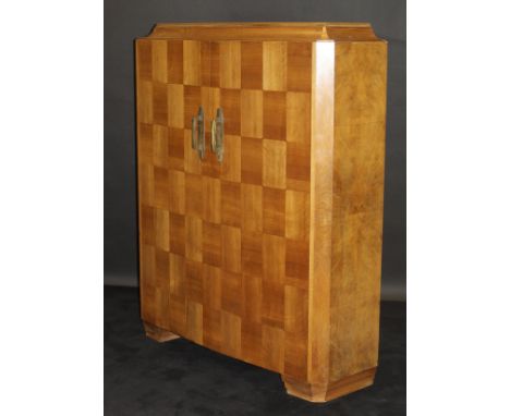 A 1920's Art Deco French walnut cabinet by Dominique of Paris, the caddy top with silver plated banding above two parquetry i