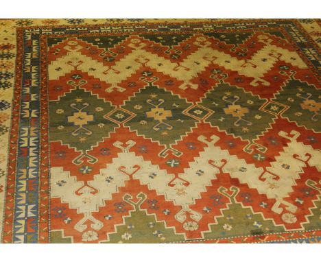 A Tukish Kayan carpet, the central medallion in green, pale apricot and cream, flanked by a pair of similar medallions, on a 