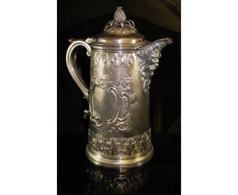 A William IV silver and embossed jug with Bacchus face mask spout and pineapple finial (Joseph Angell and John Angell, London