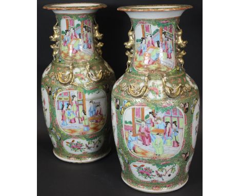 A pair of 19th Century Chinese famille-rose polychrome decorated vases with flared rims, the handles as lions playing with a 