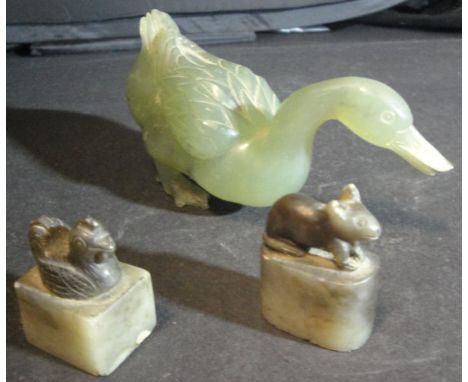 A carved jade figure of a goose together with a carved jade figure of a rat and another as a cockerel, both on pedestal bases