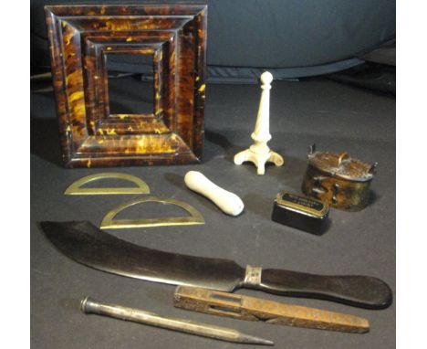 A box containing a tortoiseshell picture frame,  17.4 cm x 15.6 cm, an ebony paper knife in the form of an Indian sword tampe