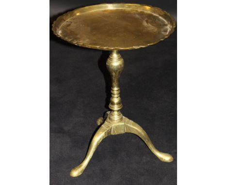 A 19th Century brass tripod wine table with dished top, the rim in a petal design raised on a single turned column to tripod 