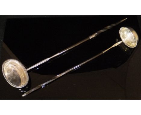 A George III whale bone handled silver punch ladle (London, 1809), together with another similar ladle, 40 cm and 35.5 cm lon