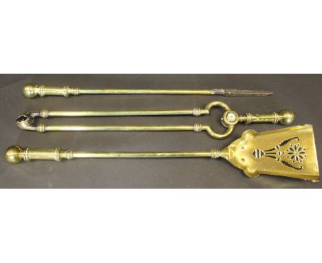 A set of three 19th Century brass fire irons to include shovel, poker and tongs, with ball finial to the handle, 69 cm long