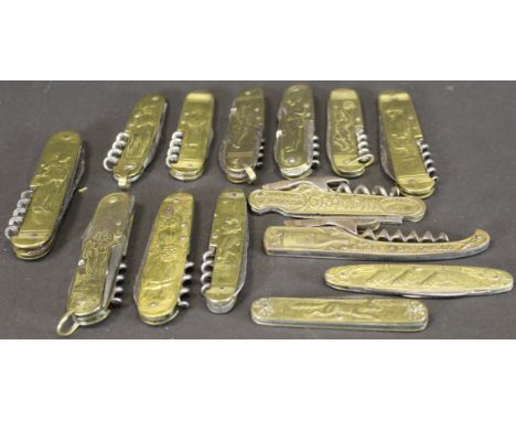 A collection of various brass cased penknives, pocket knives and bottle openers, each with relief work decoration including b