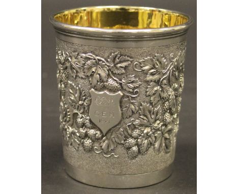 A Victorian silver beaker of tapered cylindrical form, the central textured band embossed with grape and vine / wild strawber