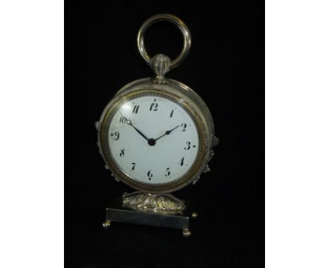 A Victorian mantle clock in the form of an over-sized pocket watch with engine turned decoration and cast grape and vine supp