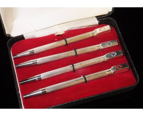 A cased set of four silver Bridge pencils, each finial with a different suit (Birmingham, 1989), each 8.5 cm long